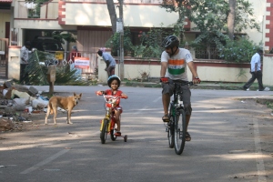 Disha rides her bicycle with Appa