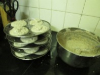 Idli plates are loaded with ragi + urad batter and are ready to steam.